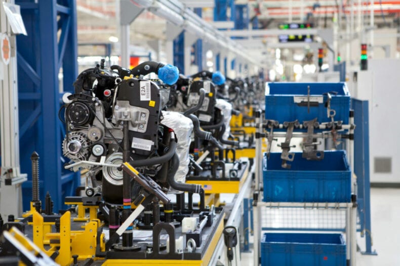 Car engine being assembled on warehouse production line
